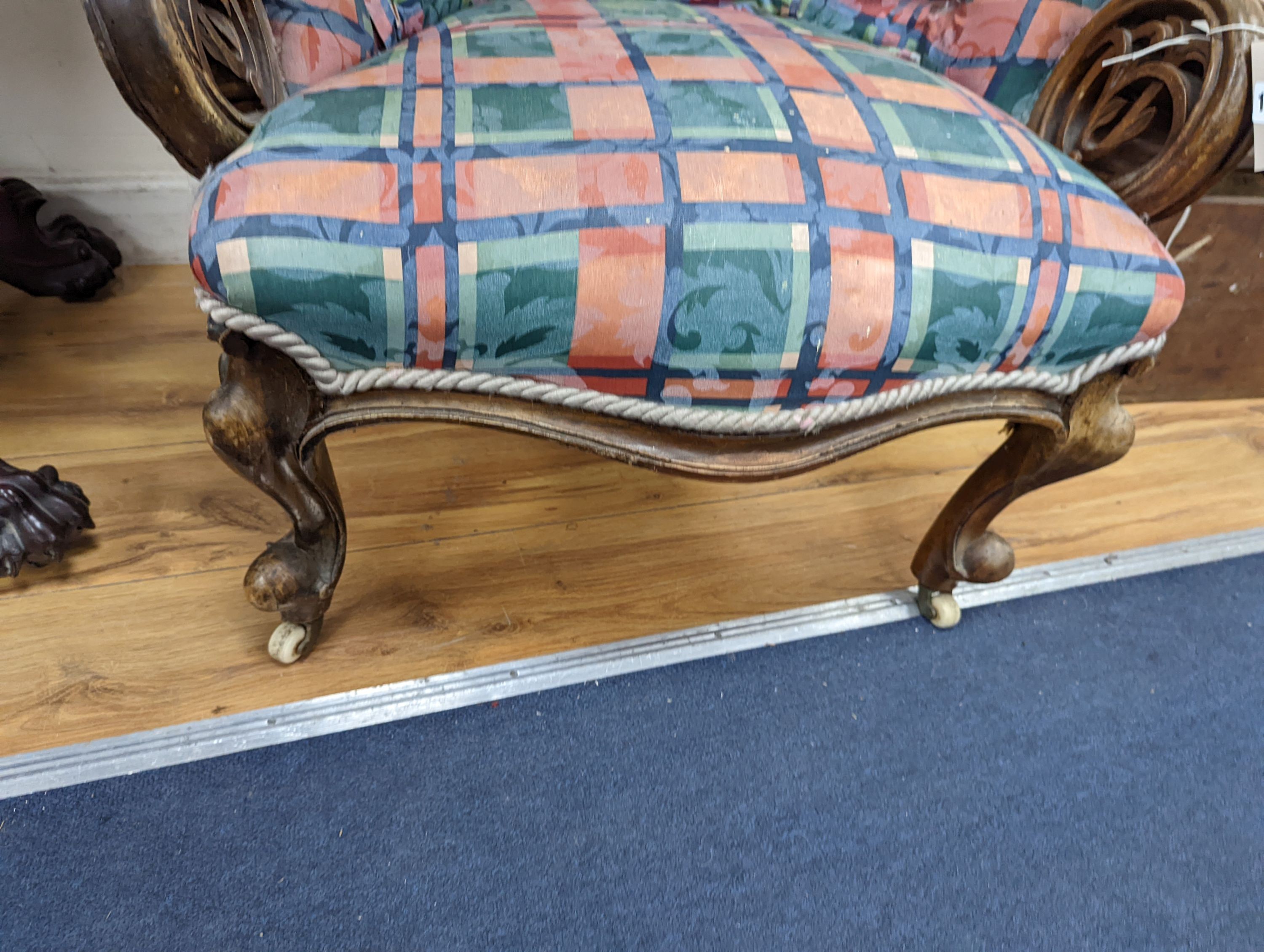 A Victorian carved walnut button back armchair